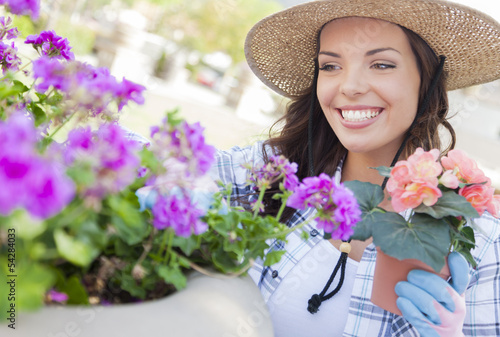 Photo: Content Young Adult Woman Wearing Hat Gardening Outdoors Content Young Adult Woman Wearing Hat Gardening Outdoors
