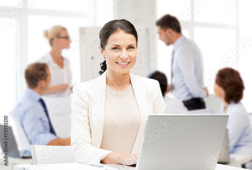 Photo: businesswoman with laptop computer at work businesswoman with laptop computer at work