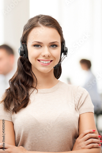 Photo: helpline operator with headphones in call centre helpline operator with headphones in call centre