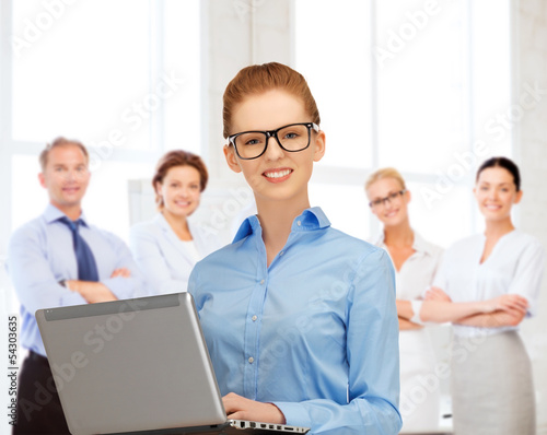 Photo: businesswoman with laptop computer at work businesswoman with laptop computer at work