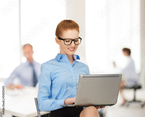 Photo: businesswoman with laptop computer at work businesswoman with laptop computer at work