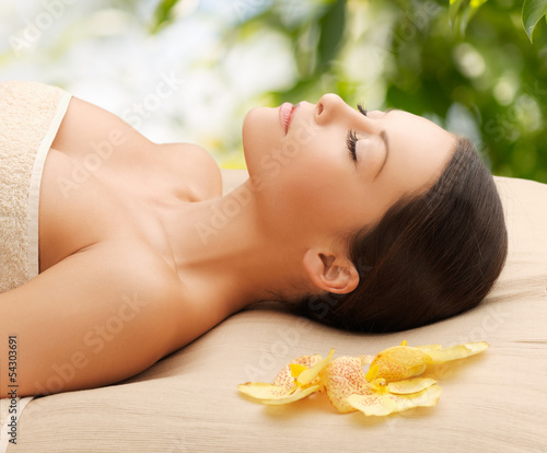 Photo: woman in spa lying on the massage desk woman in spa lying on the massage desk