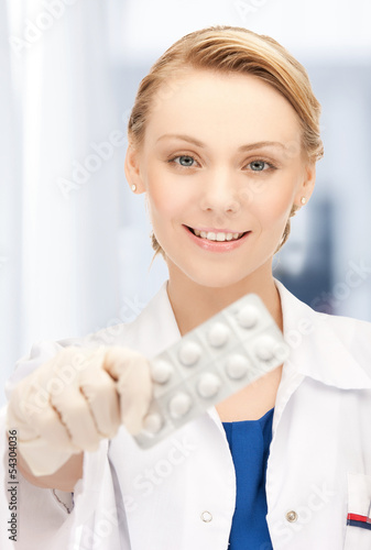Photo: doctor with blister pack of pills doctor with blister pack of pills