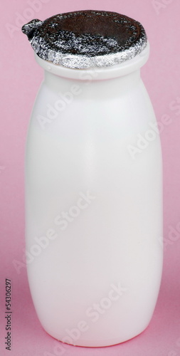Photo: white bottle on pink background white bottle on pink background
