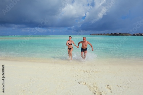 Photo: happy young couple at summer vacation have fun and relax at bea happy young couple at summer vacation have fun and relax at bea