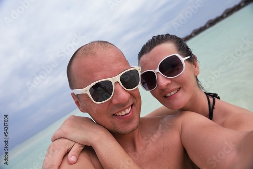 Photo: happy young couple at summer vacation have fun and relax at bea happy young couple at summer vacation have fun and relax at bea