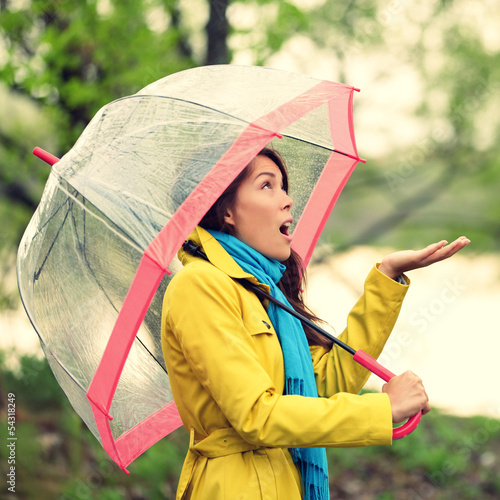 Photo: Umbrella woman in Autumn excited under rain Umbrella woman in Autumn excited under rain