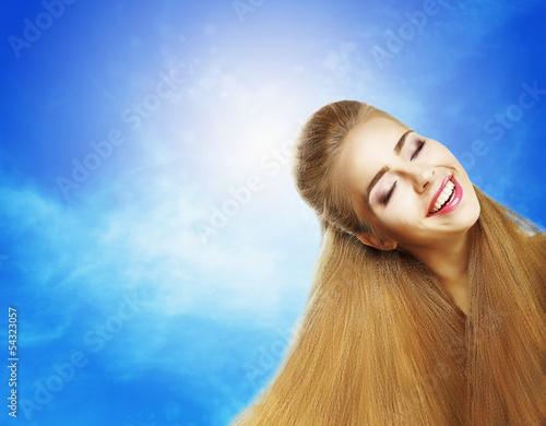 Photo: Positive Emotions. Laughing Teen Girl on Blue Sky. Jubilance Positive Emotions. Laughing Teen Girl on Blue Sky. Jubilance