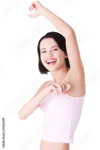 Photo: Beautiful young woman using antiperspirant Beautiful young woman using antiperspirant