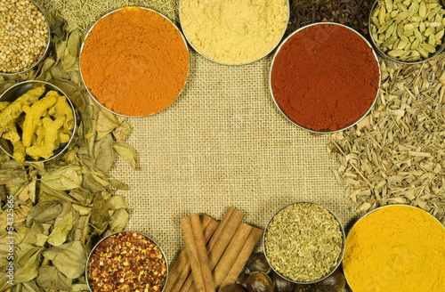 Photo: Herbs and spices on hessian background Herbs and spices on hessian background