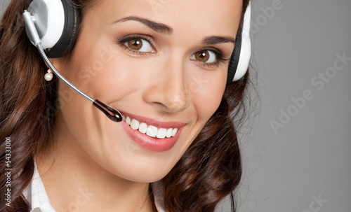 Photo: Support phone operator in headset, on gray Support phone operator in headset, on gray