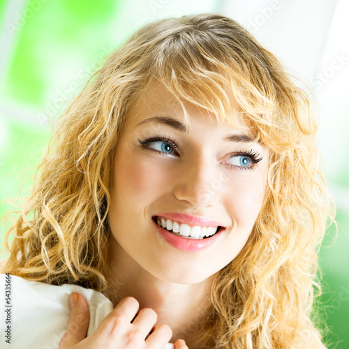 Photo: Young woman waking up on bed Young woman waking up on bed