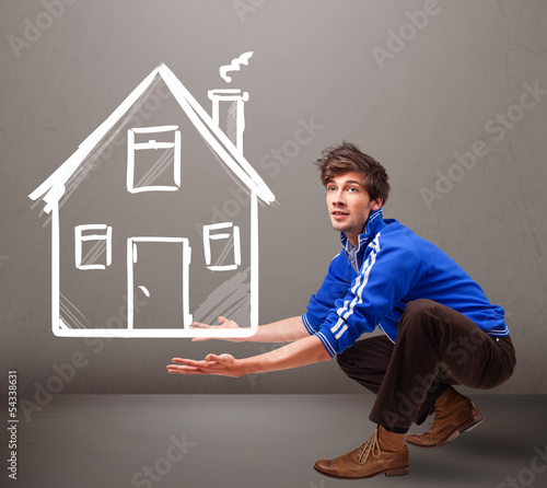 Photo: Young boy holding a huge drawn house Young boy holding a huge drawn house