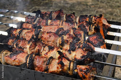 Photo: Delicious meat kebabs grilling over fire portable Delicious meat kebabs grilling over fire portable