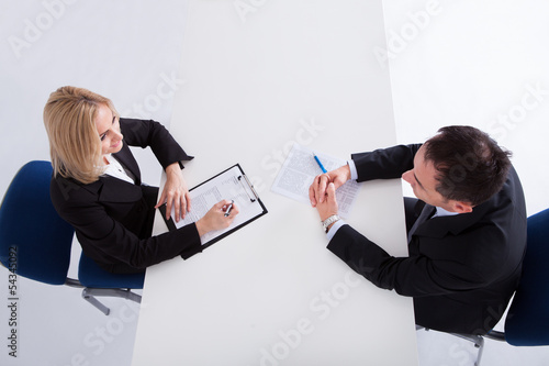 Photo: Two Businesspeople Talking With Each Other Two Businesspeople Talking With Each Other