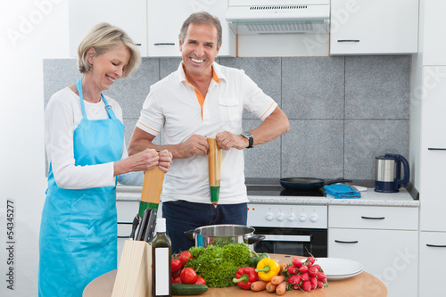 Photo: Mature Couple Cooking In Kitchen Mature Couple Cooking In Kitchen