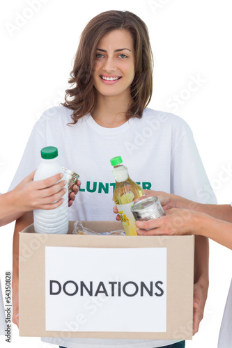 Photo: Smiling volunteer holding a food donation box Smiling volunteer holding a food donation box