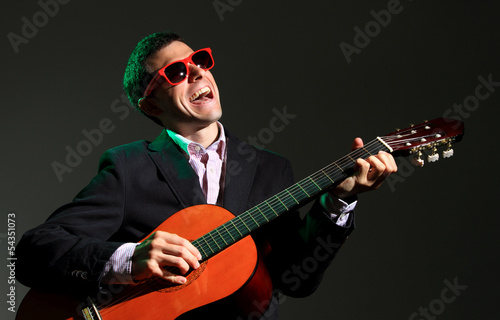 Photo: Guitar player on black background Guitar player on black background