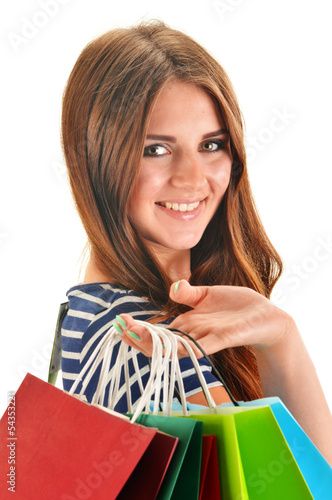 Photo: Young happy woman with colorful paper shopping bags isolated Young happy woman with colorful paper shopping bags isolated