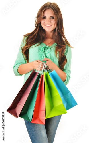Photo: Young happy woman with colorful paper shopping bags isolated Young happy woman with colorful paper shopping bags isolated