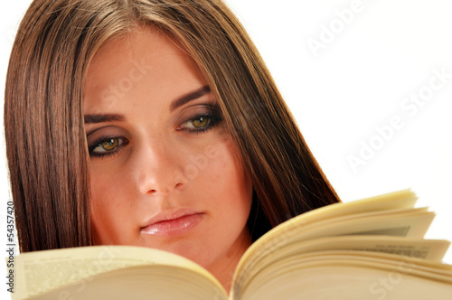 Photo: Young woman reading a book. Female student learning Young woman reading a book. Female student learning