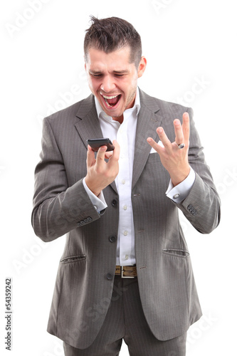 Photo: Angry business man screaming on cell mobile phone Angry business man screaming on cell mobile phone