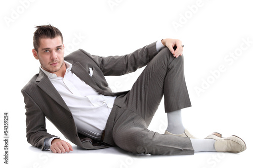 Photo: Portrait of business man sitting on the floor isolated Portrait of business man sitting on the floor isolated