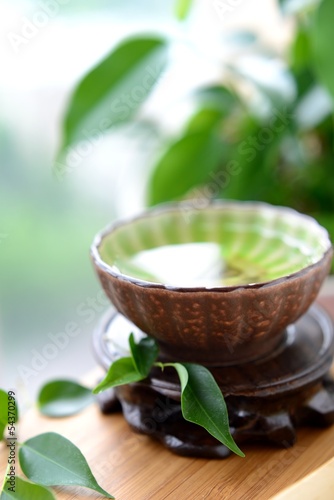 Photo: Healthy green tea cup with leaves Healthy green tea cup with leaves