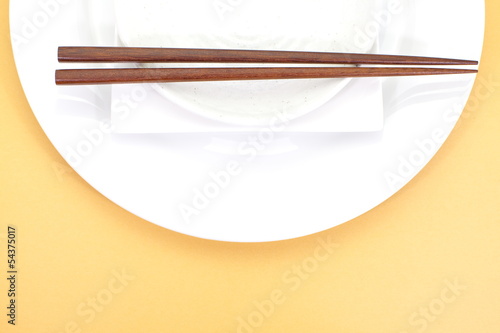 Photo: Empty white plate with chopsticks Empty white plate with chopsticks