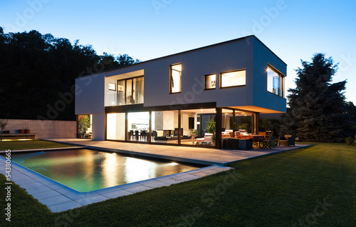 Photo: Modern villa with pool, night scene Modern villa with pool, night scene