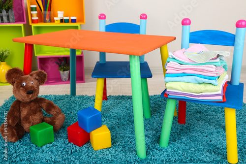 Photo: Small and colorful table and chairs with baby clothes Small and colorful table and chairs with baby clothes