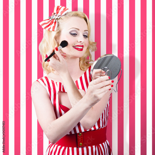 Photo: Beautiful cosmetic woman applying make-up base Beautiful cosmetic woman applying make-up base