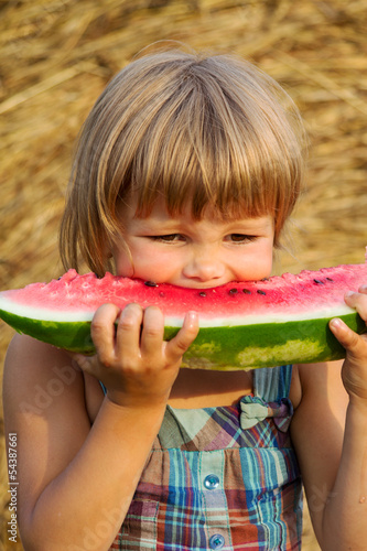 Photo: The portrait of the girl eats water-melon The portrait of the girl eats water-melon