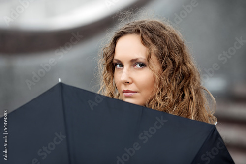 Photo: Sad beautiful woman with umbrella Sad beautiful woman with umbrella