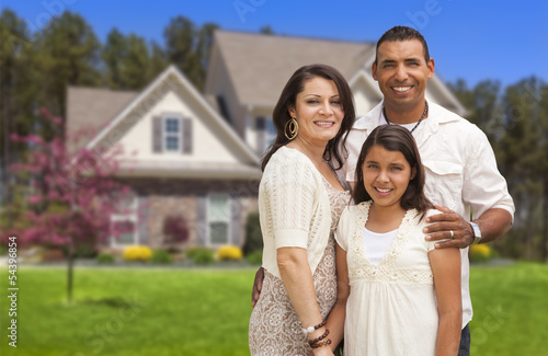 Photo: Small Hispanic Family in Front of Their Home Small Hispanic Family in Front of Their Home