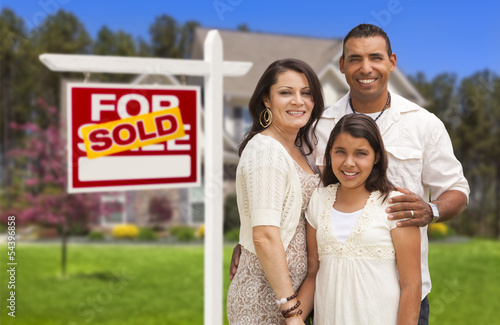 Photo: Hispanic Family in Front of Their New Home and Sign Hispanic Family in Front of Their New Home and Sign