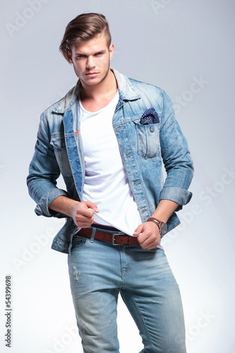 Photo: cute young man pulling his shirt cute young man pulling his shirt