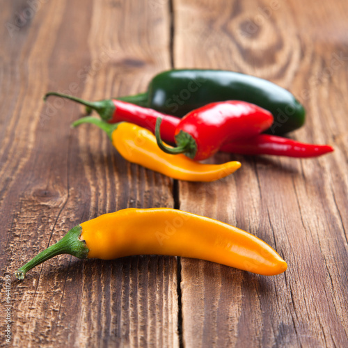 Photo: Yellow chili and a group on wood Yellow chili and a group on wood