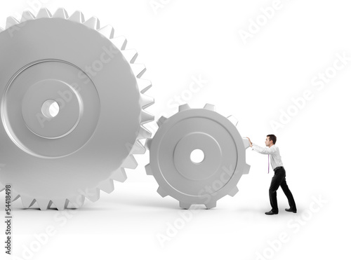 Photo: man pushing a gears man pushing a gears