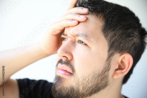 Photo: man in his thirties with a bad headache man in his thirties with a bad headache