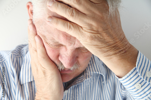 Photo: mature man has severe headache mature man has severe headache
