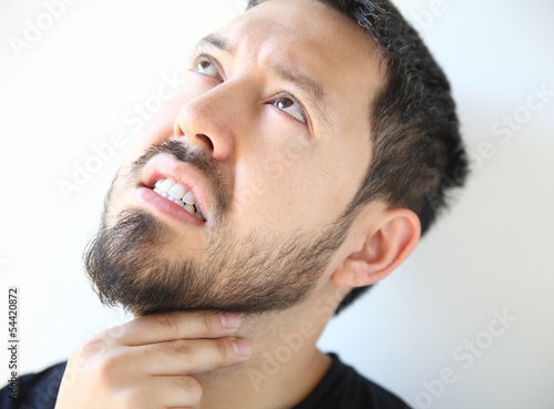 Photo: bearded young man with a sore throat bearded young man with a sore throat