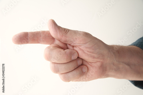 Photo: senior man points a finger to the left senior man points a finger to the left