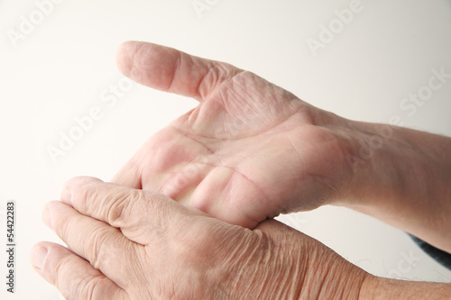 Photo: older man bends hand back older man bends hand back