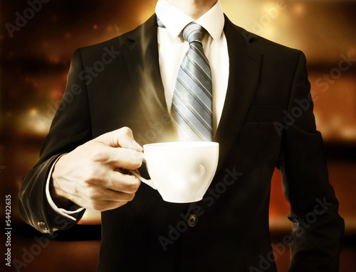 Photo: Business Man Holding a Cup of Coffee Business Man Holding a Cup of Coffee