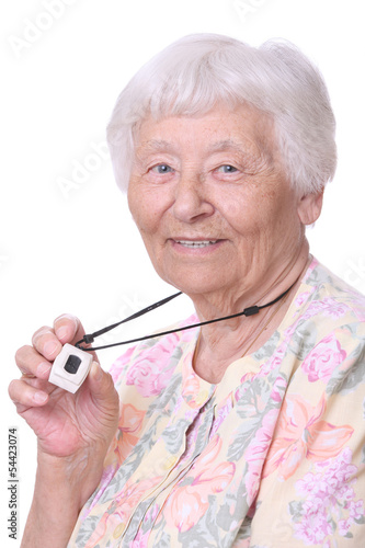Photo: Senior woman wearing a medical emergency panic button pendant Senior woman wearing a medical emergency panic button pendant
