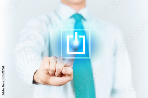 Photo: Young man press the power button Young man press the power button