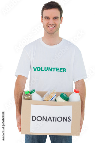 Photo: Handsome man carrying donation box with food Handsome man carrying donation box with food