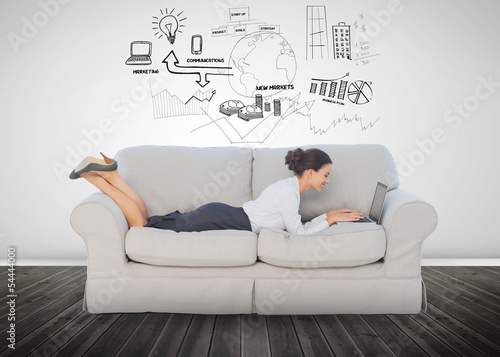 Photo: Cheerful businesswoman lying on couch Cheerful businesswoman lying on couch