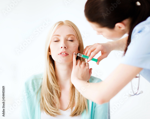 Photo: beautician with patient doing botox injection beautician with patient doing botox injection
